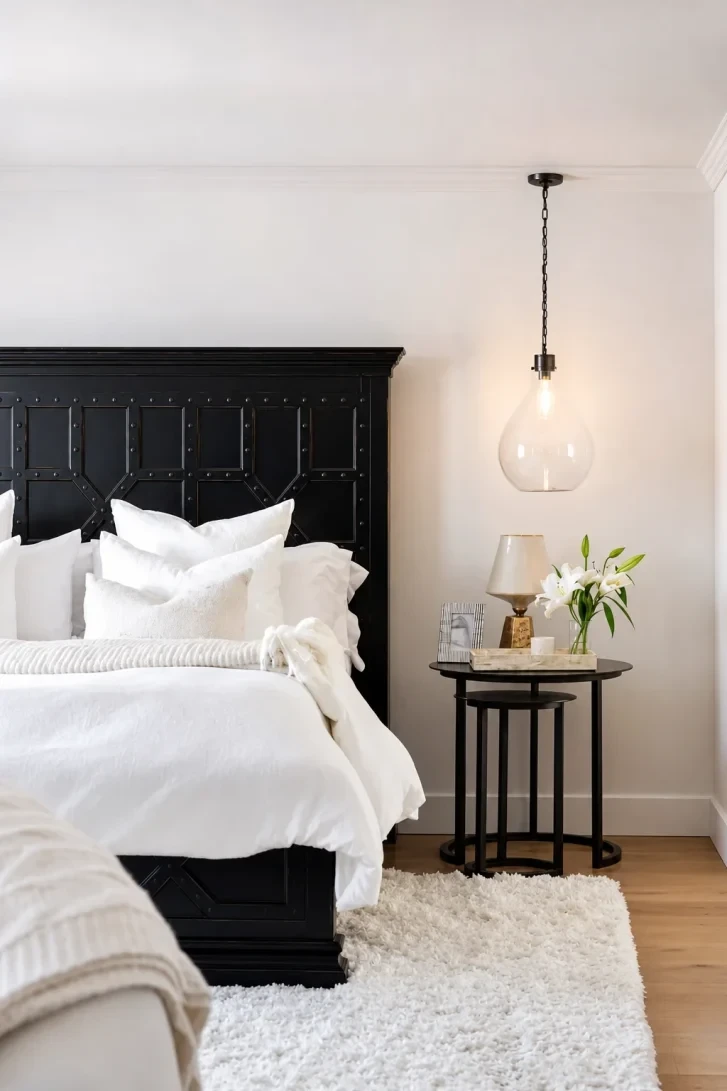 Carved Black Headboard Dominates an All-White Room