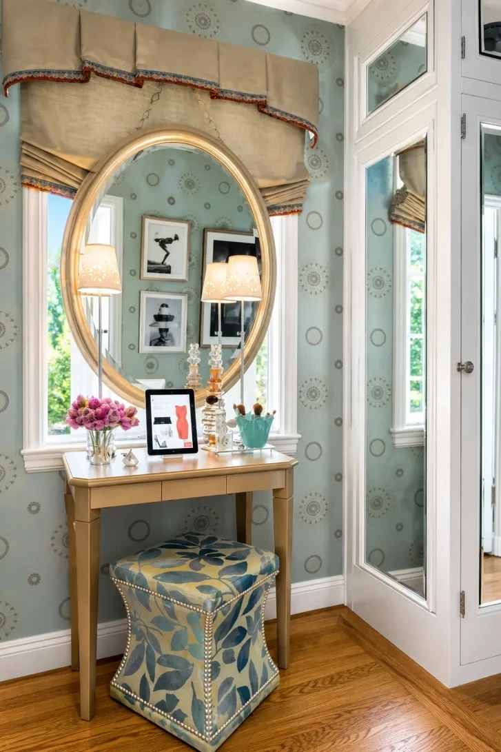 Gold Oval Mirror Hung Between Two Windows