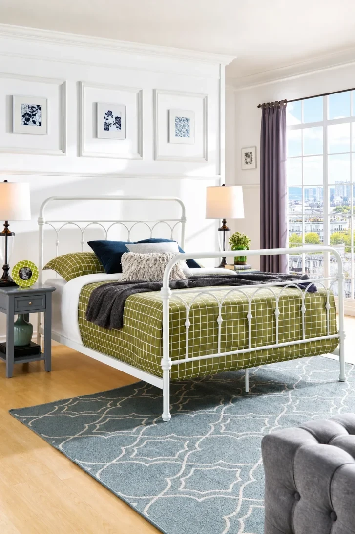 Olive Grid Bedding Against a White Iron Frame