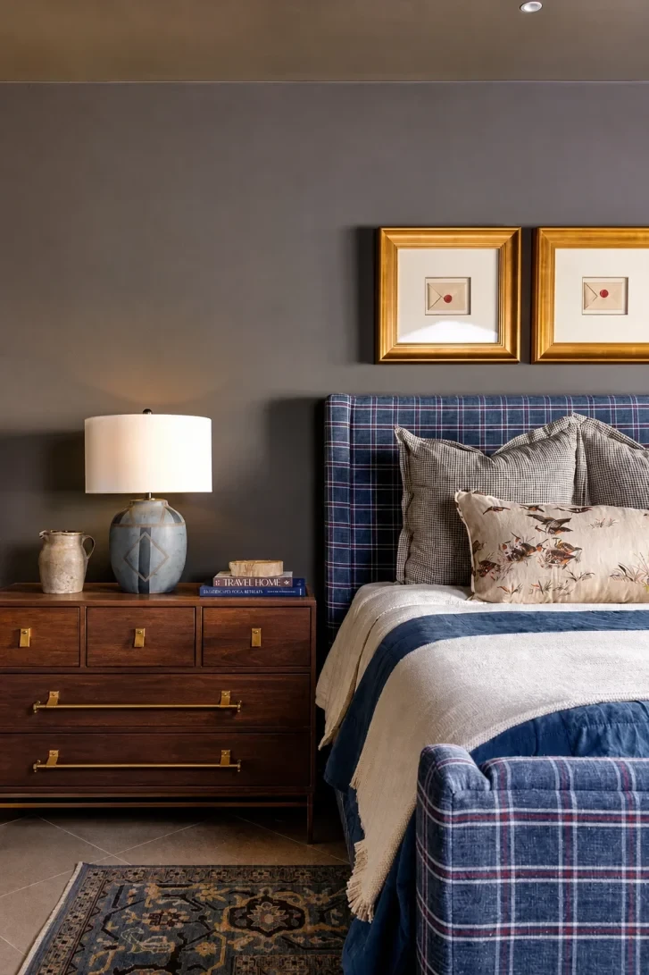 Plaid Upholstered Bed Anchors a Rich, Layered Retreat